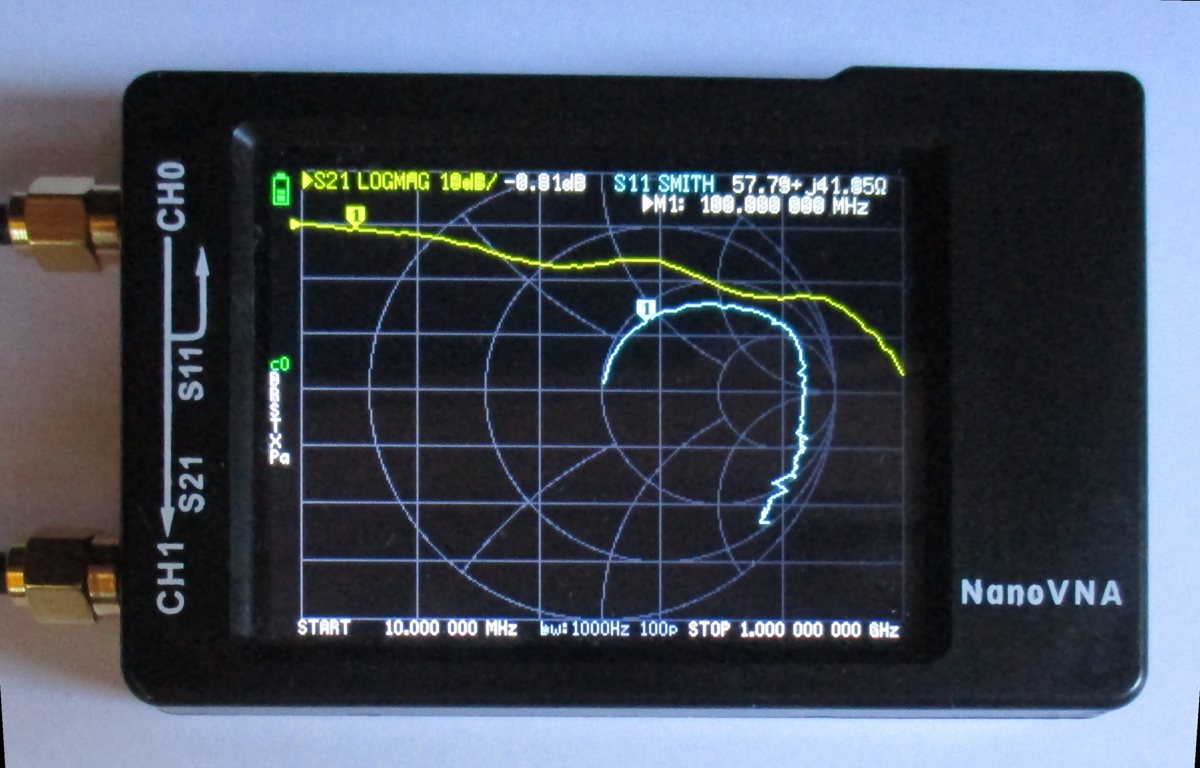 Display eines NanoVNA-H: gelbe S21-Kurve von links oben nach rechts unten fallend, blaue S11-Kurve als Bogen im Smith-Diagramm, oben die Werte S21 LOGMAG -0,81 dB und S11 SMITH 57,79 + j41,05 Ohm beim Marker 100 MHz, links der Kalibrierstatus c0 mit den Buchstaben D R S T X